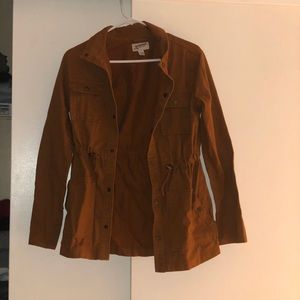 Brownish jacket. Light coat.